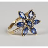 A 9ct gold, mauve and colourless gem set ring in a flowerhead cluster design, weight 3.6g, ring size