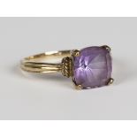 A 9ct gold ring, mounted with a cushion cut amethyst between ropetwist decorated shoulders, weight