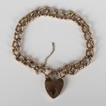 A gold hollow curblink bracelet, detailed '9c', length 19cm, on a gold heart shaped padlock clasp,