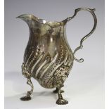 A Victorian silver cream jug with scroll handle, the baluster body with spiral fluted decoration, on
