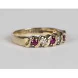 A 9ct gold, ruby and diamond five stone ring, mounted with three circular cut rubies alternating
