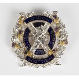 A two colour gold, diamond, amethyst and blue enamelled military brooch badge, detailed 'London