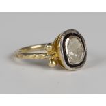 A silver gilt and diamond ring, probably Indian, mounted with a principal foil backed flat cut