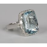 An 18ct white gold, aquamarine and diamond ring, claw set with a large rectangular cut aquamarine