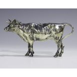 An early 20th century German silver cow creamer, modelled standing with tail forming the handle, the