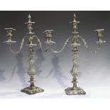 A pair of 19th century Sheffield plate twin-branch three-light candelabra, each with urn shaped