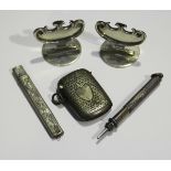 A pair of Edwardian silver place settings/menu holders, each of scroll outline on a circular base,