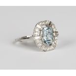 An aquamarine and diamond ring, claw set with an oval cut aquamarine within an openwork surround,