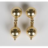 A pair of 18ct gold pendant earrings, each hemispherical surmount with a spherical pendant drop,