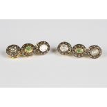 A pair of silver gilt, diamond and emerald earrings, each in a triple cluster design, mounted with