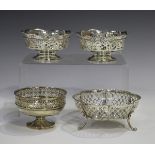 A pair of Edwardian silver bonbon baskets, each with pierced rim and sides, on a circular foot,