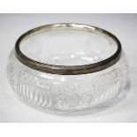 A George V silver mounted cut glass fruit bowl, the silver rim with bead and reel decoration,