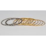 A group of eight mostly Middle Eastern gold bangles in a variety of designs, total weight 69.8g,