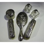 An Art Nouveau silver mounted part dressing table set, decorated in relief with irises, comprising