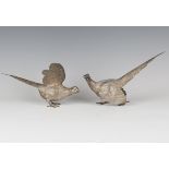 A pair of Elizabeth II silver models of cock and hen pheasants with engraved plumage, London 1979 by