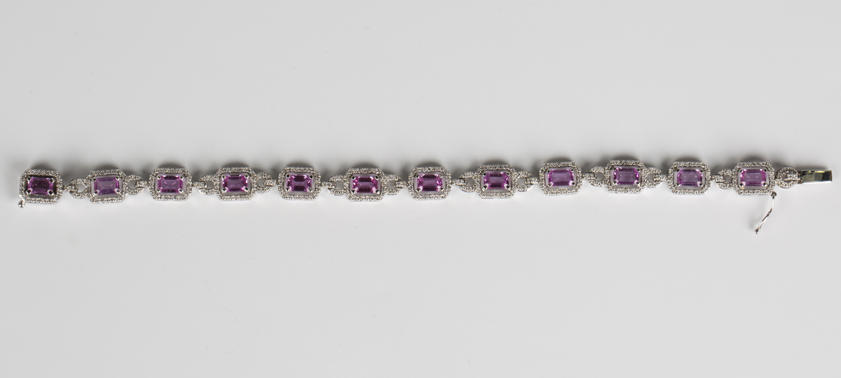 An 18ct white gold, pink sapphire and diamond bracelet, each canted corner rectangular link claw set