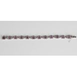 An 18ct white gold, pink sapphire and diamond bracelet, each canted corner rectangular link claw set