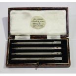 A set of four sterling silver propelling bridge pencils, each with engine turned decoration, cased.