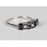 An 18ct white gold, sapphire and diamond ring, claw set with four pairs of marquise cut sapphires