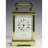 A late 20th century lacquered brass carriage clock with eight day movement striking on a bell, the