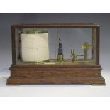 An early 20th century oak cased barograph with brass mechanism and clockwork recording drum, applied