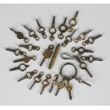 A collection of twenty-five pocket and fob watch keys, including one advertising watch key.Buyer’s