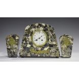 An Art Deco gilt metal mounted marble mantel clock garniture, the clock with eight day movement