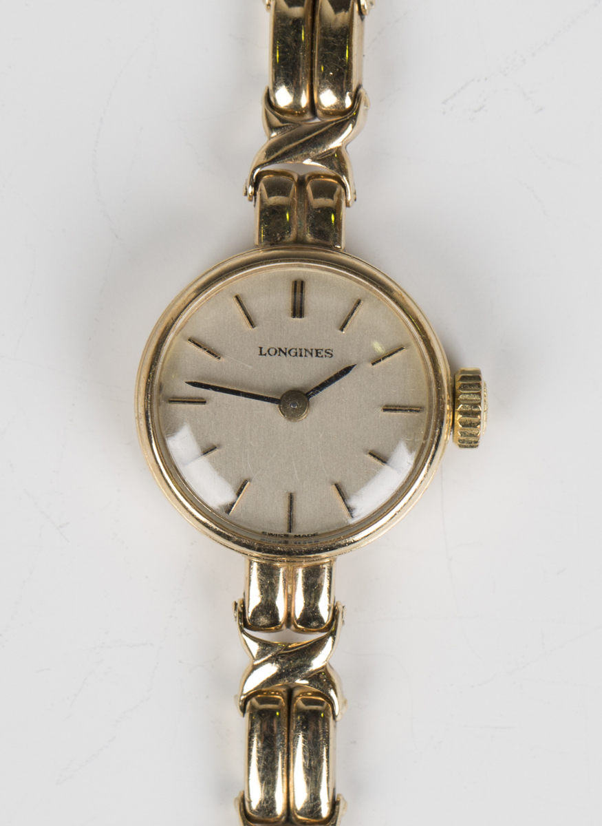 A Longines 9ct gold lady's bracelet wristwatch, the signed silvered dial with baton hour markers and