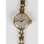 A Longines 9ct gold lady's bracelet wristwatch, the signed silvered dial with baton hour markers and