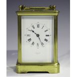 A 20th century French lacquered brass carriage timepiece with eight day movement, the white enamel