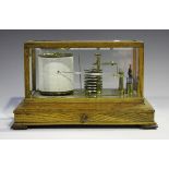 An early 20th century oak cased barograph with brass mechanism and clockwork recording drum,
