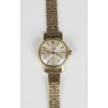 An Omega gilt metal fronted and steel backed lady's wristwatch, the signed silvered dial with
