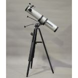 A Bushnell Model 78-9518 telescope with 900mm focal length and 4.5" objective lens, on a black