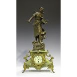 An early 20th century gilt metal, spelter and onyx mantel timepiece, the case surmounted with a