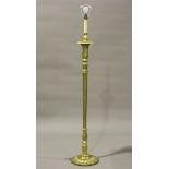 A 20th century Italianate giltwood lamp standard with a carved foliate stem and circular base,