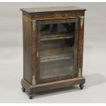 A late Victorian walnut and gilt metal mounted pier cabinet, fitted with a glazed door, raised on