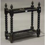 A late Victorian oak two-section stick stand, height 68cm, width 63cm, depth 25cm.Buyer’s Premium