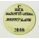 A mid-Victorian ivory theatre token or pass, inscribed 'Her Majesty's Opera Drury Lane 1868',