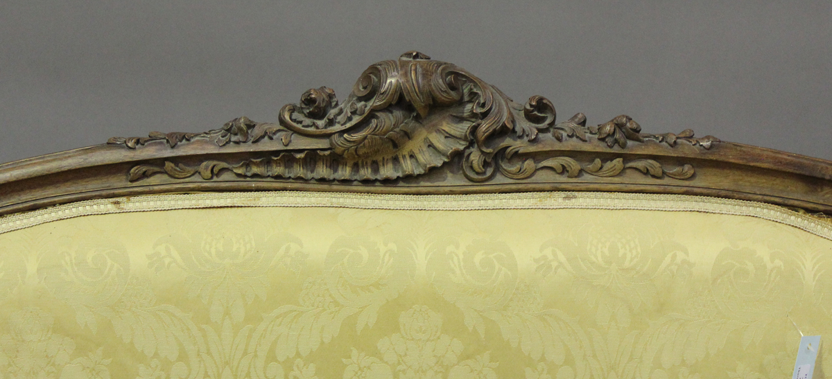 A late 19th century French Louis XV style walnut showframe salon suite, comprising a settee, - Image 10 of 12