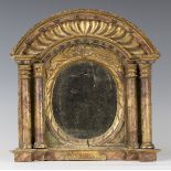 An early 20th century Continental giltwood and simulated marble arched niche, inset with a central