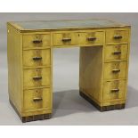 An Art Deco maple and coromandel crossbanded desk, the top inset with tooled leather above an