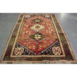 A Ghashghai carpet, South-west Persia, late 20th century, the deep red field with three linked and