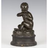 A 19th century French brown/green patinated cast bronze figure of a seated putto feeding a bird,