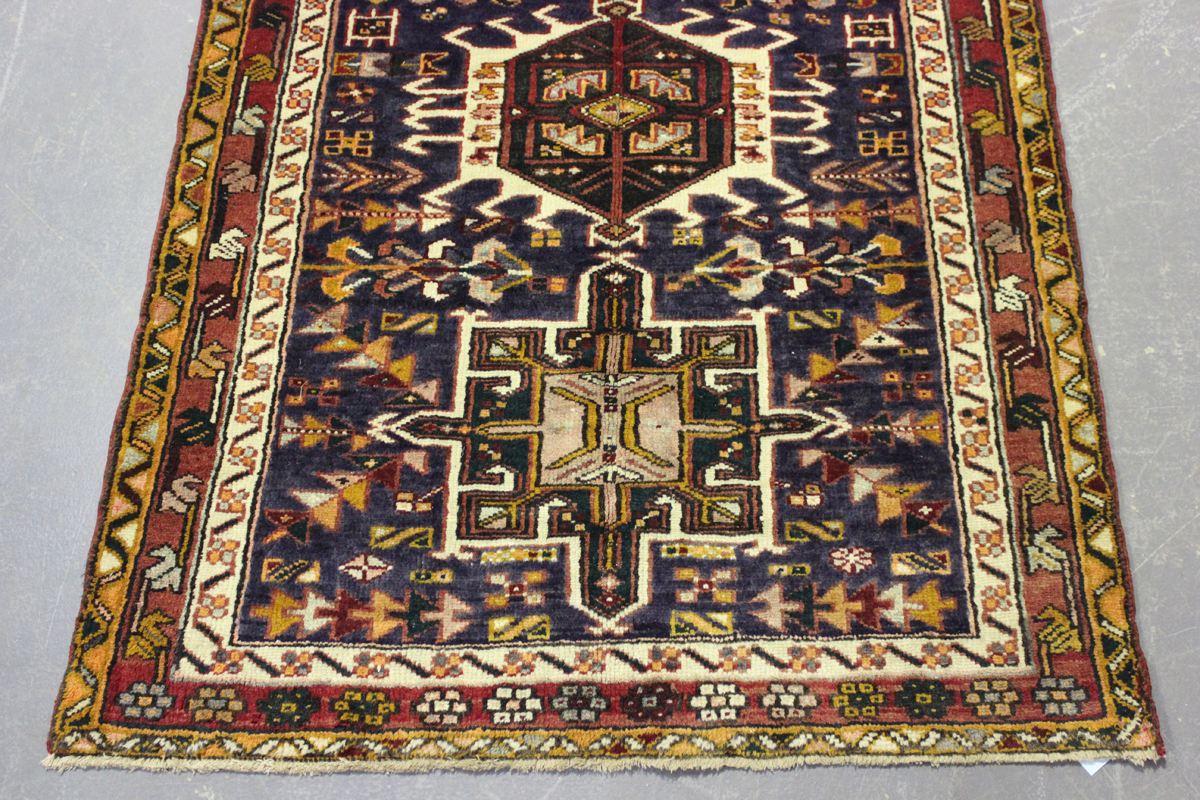 A Heriz runner, North-west Persia, mid-20th century, the midnight blue field with a column of nine - Image 2 of 5