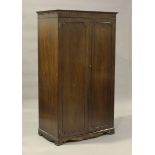 A modern mahogany wardrobe by Marks & Spencer, height 189cm, width 107cm, depth 64cm.Buyer’s Premium