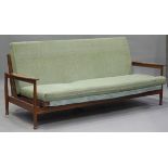 A mid-20th century Danish teak framed reclining sofa bed, in the manner of Finn Juhl, raised on