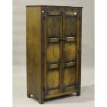 A 20th century Jacobean Revival oak two-door wardrobe, height 155cm, width 84cm, depth 47cm.Buyer’