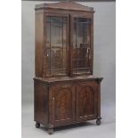 A George IV mahogany bookcase cabinet, the glazed top enclosing adjustable shelves, height 235cm,