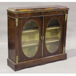 A late Victorian walnut side cabinet with gilt metal mounts, fitted with two oval glazed panel