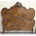 A late 19th century French kingwood double bed frame, the carved head and foot boards with foliate